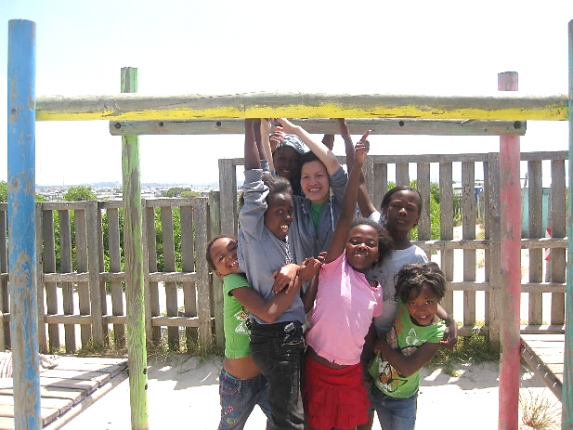 A group of children are posing for a picture on a playground