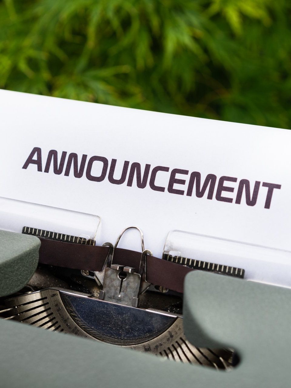 A typewriter with the word announcement typed on it