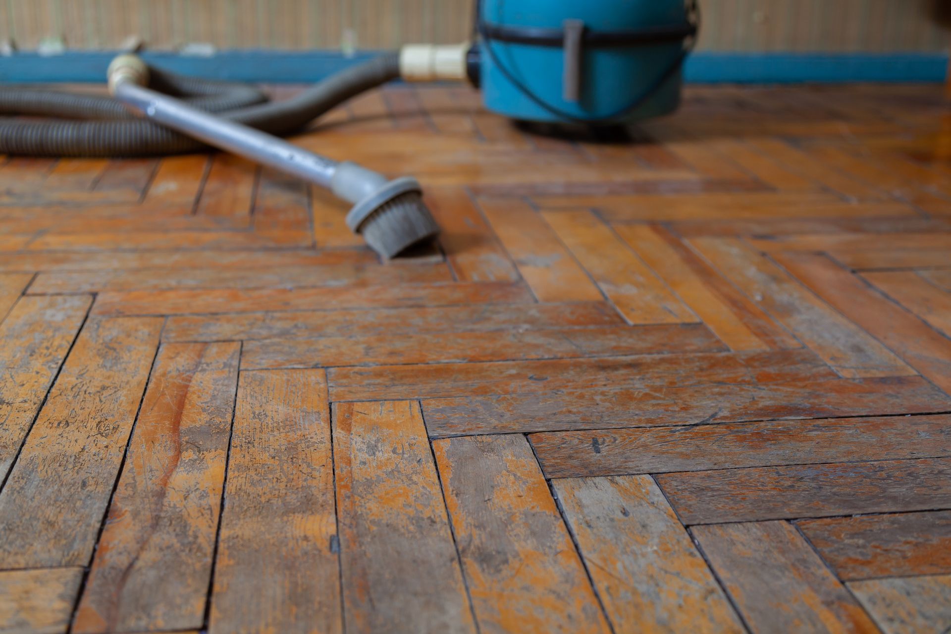 A vacuum cleaner is sitting on a wooden floor.