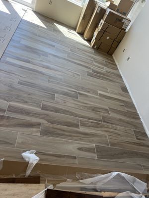 A room with a wooden floor and boxes on the wall.