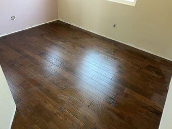 A bedroom with hardwood floors and pink walls.