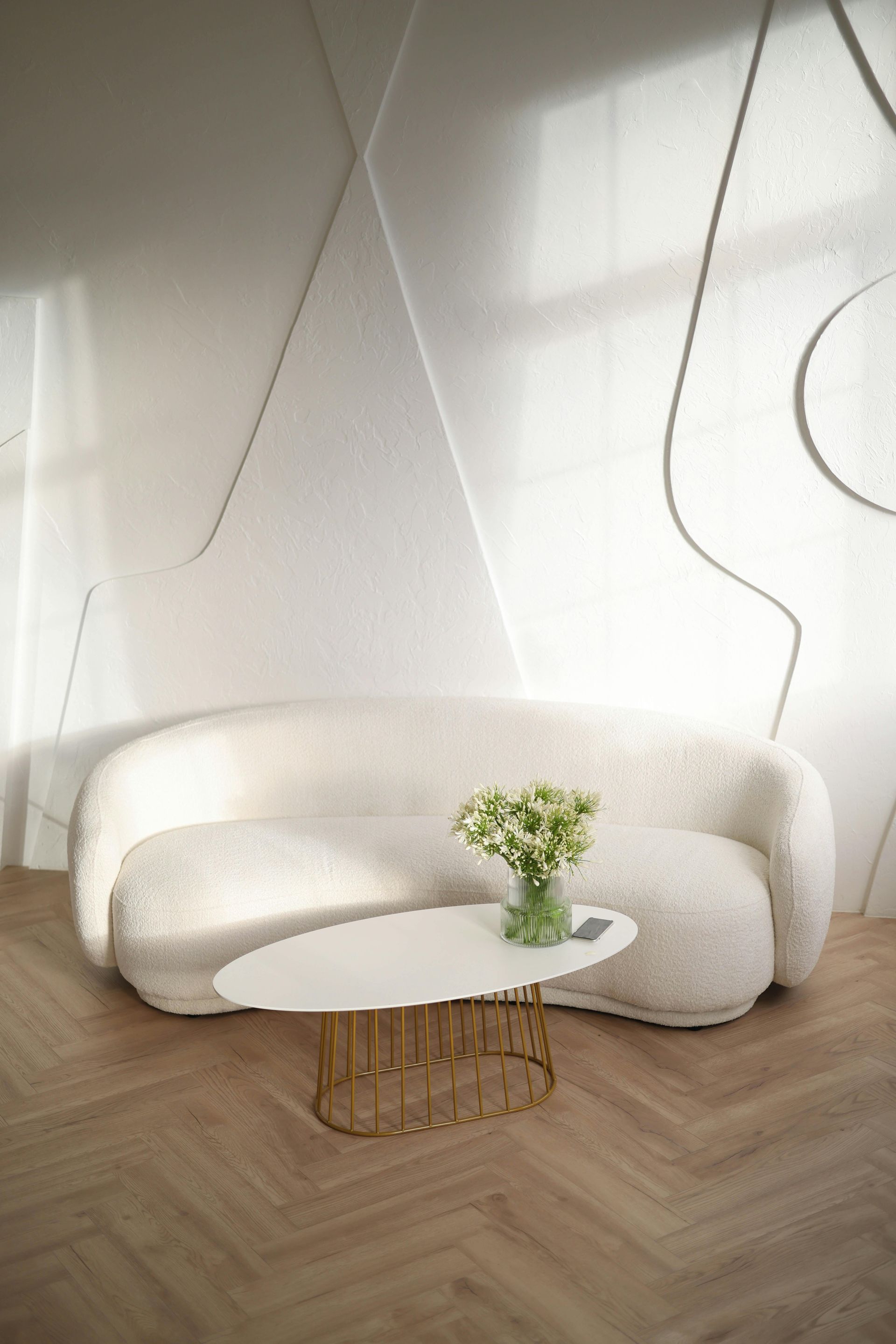 A white couch and a white coffee table in a living room.