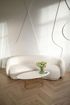 A white couch and a white coffee table in a living room.