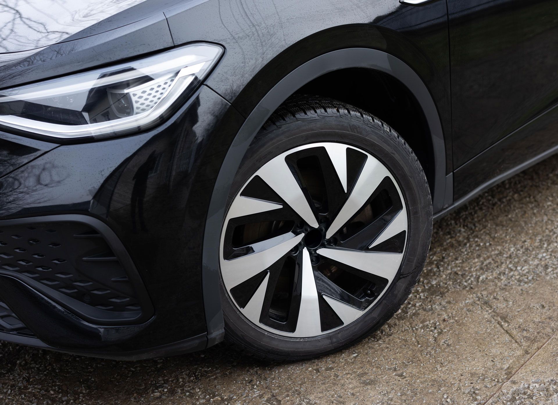Black car front wheel with silver and black spoke design.