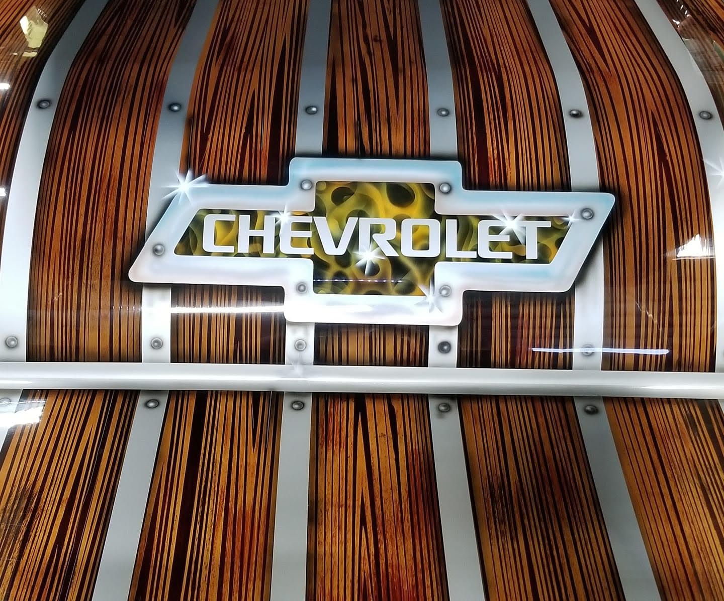 Chevrolet logo on a wooden truck bed with metal accents.