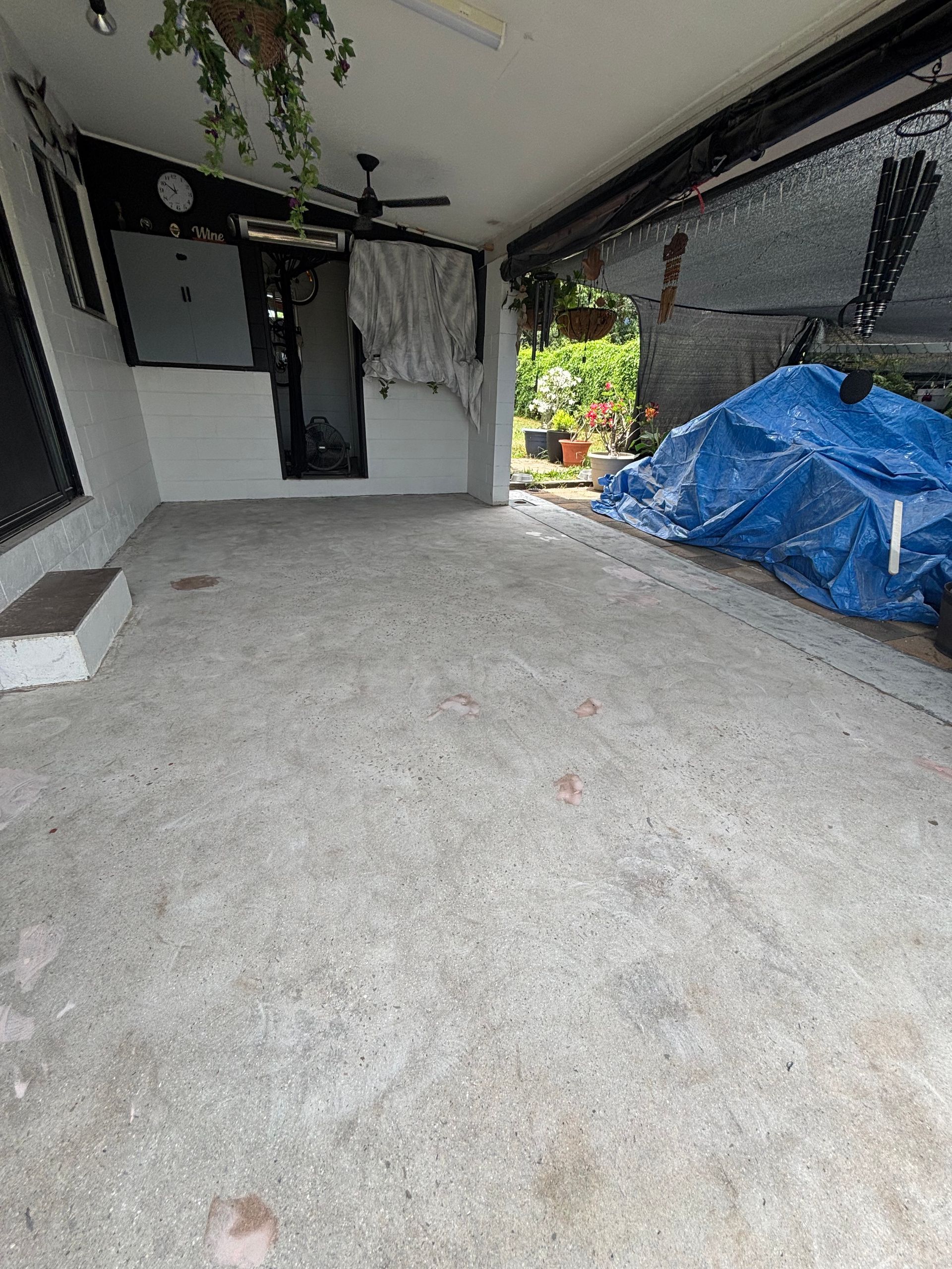 A Person is Spreading Green Paint on a Concrete Floor — Supremacy Painting Co In White Rock, QLD