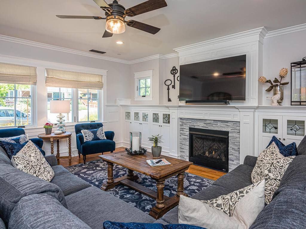 A living room filled with furniture and a fireplace.