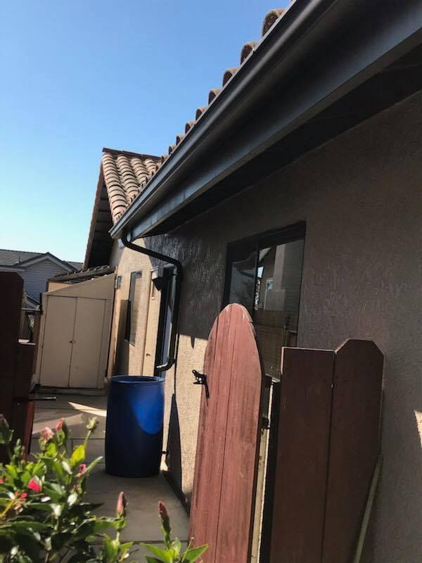 A house with a gutter on the side of it