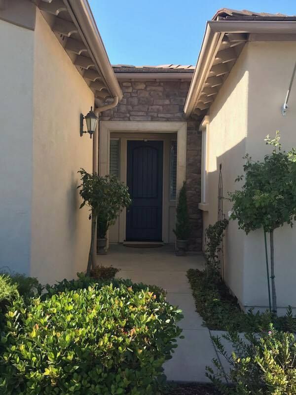 A house with a blue door and a walkway leading to it
