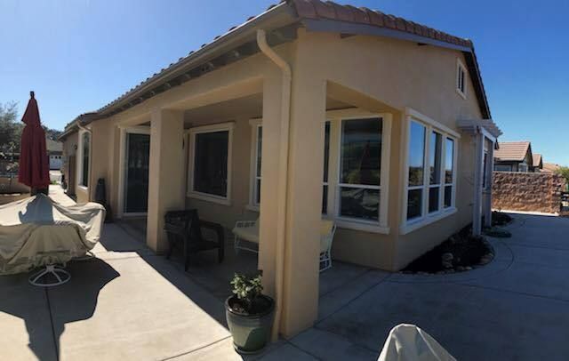 A house with a lot of windows and a patio