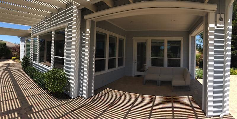 A large house with a covered porch and lots of windows