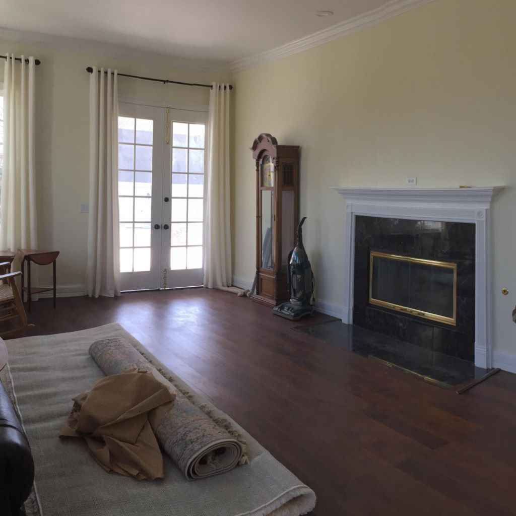 A living room with hardwood floors and a fireplace