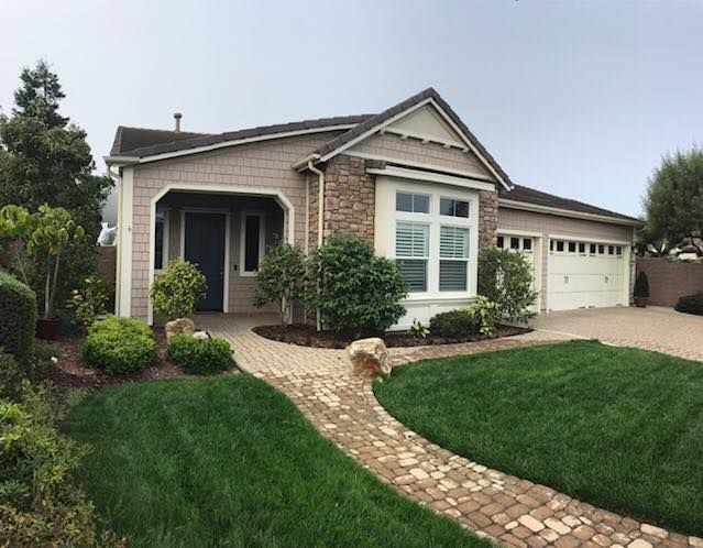 A house with a brick walkway leading to it