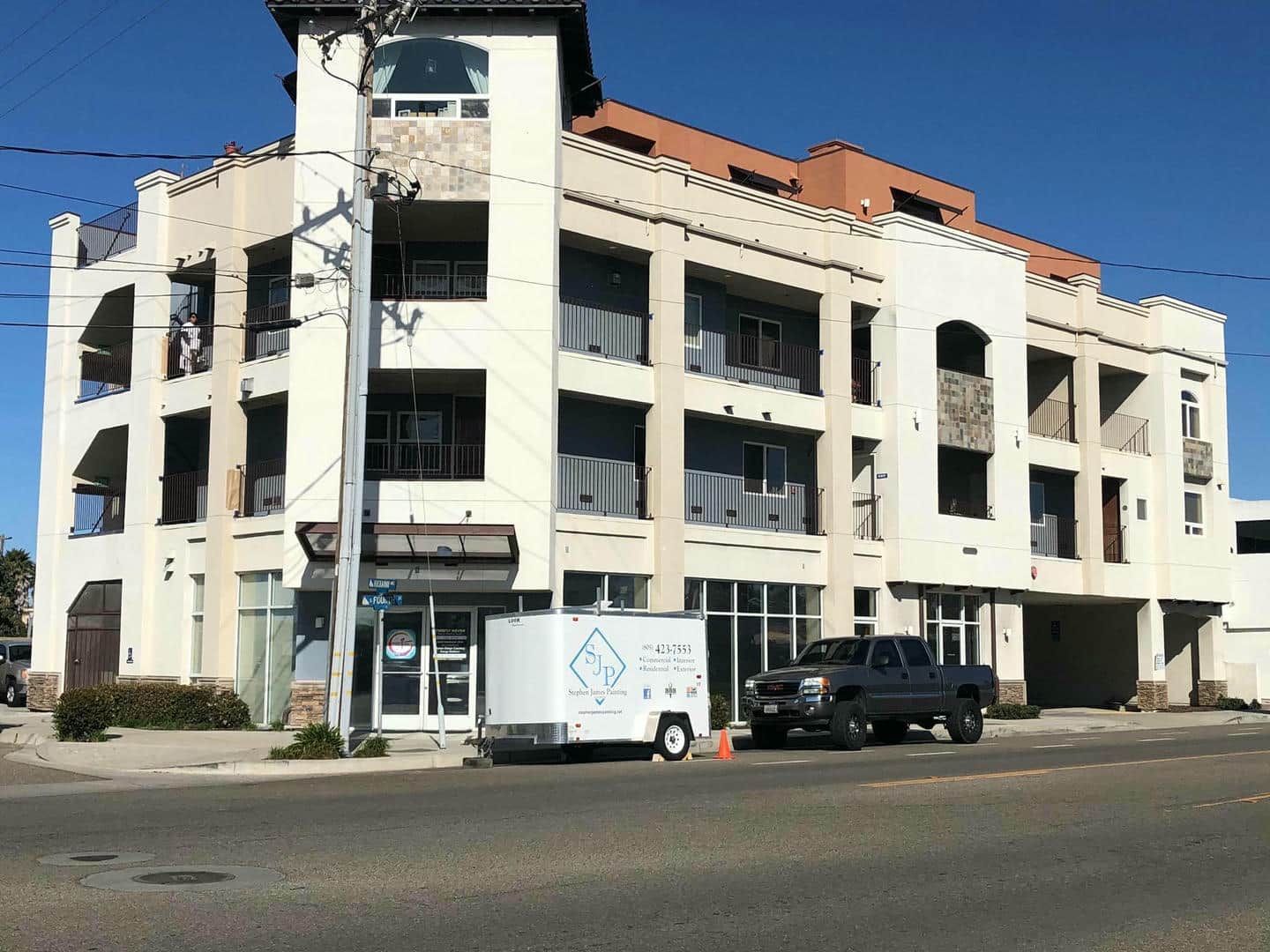 A truck is parked in front of a large building