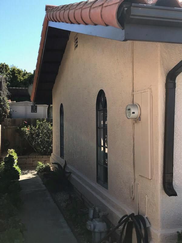 A house with a roof that has a gutter on it