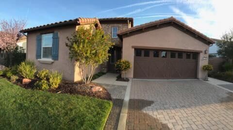 A large house with a garage and a driveway in front of it.