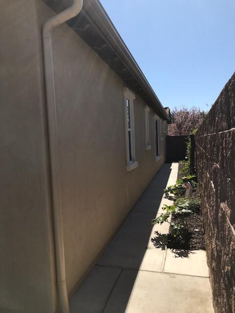 The side of a house with a walkway leading to it
