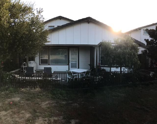 A house with a table and chairs in front of it