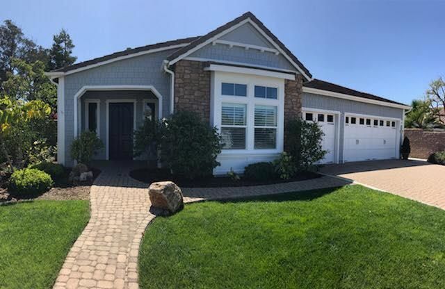 A house with a brick walkway leading to it