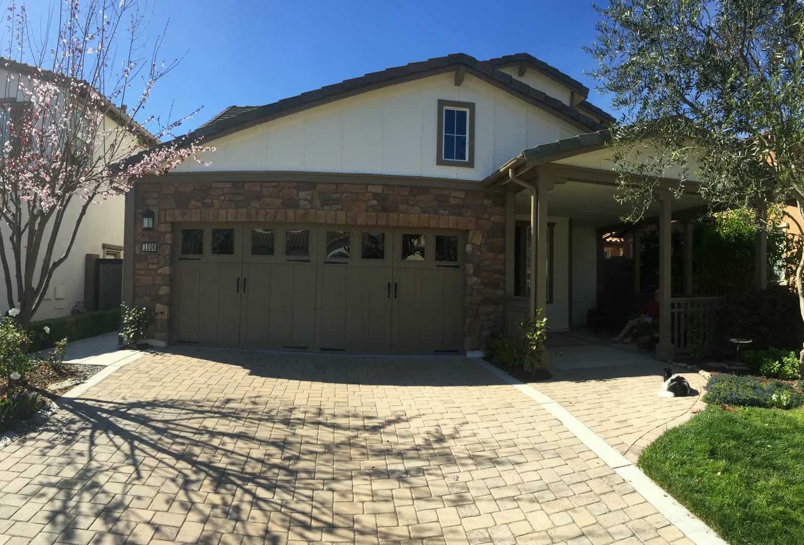 A house with a large garage and a brick driveway