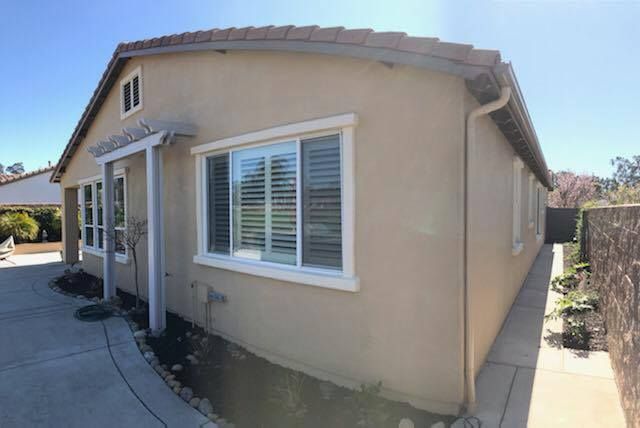 A house with a lot of windows and shutters on it