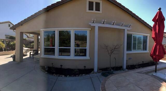 A house with a red umbrella in front of it