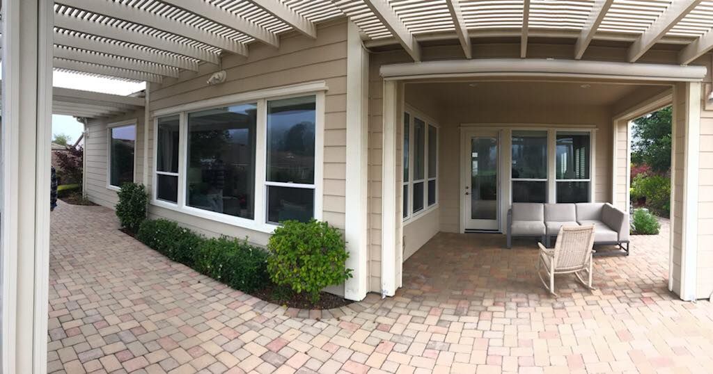 A large house with a patio and a pergola.