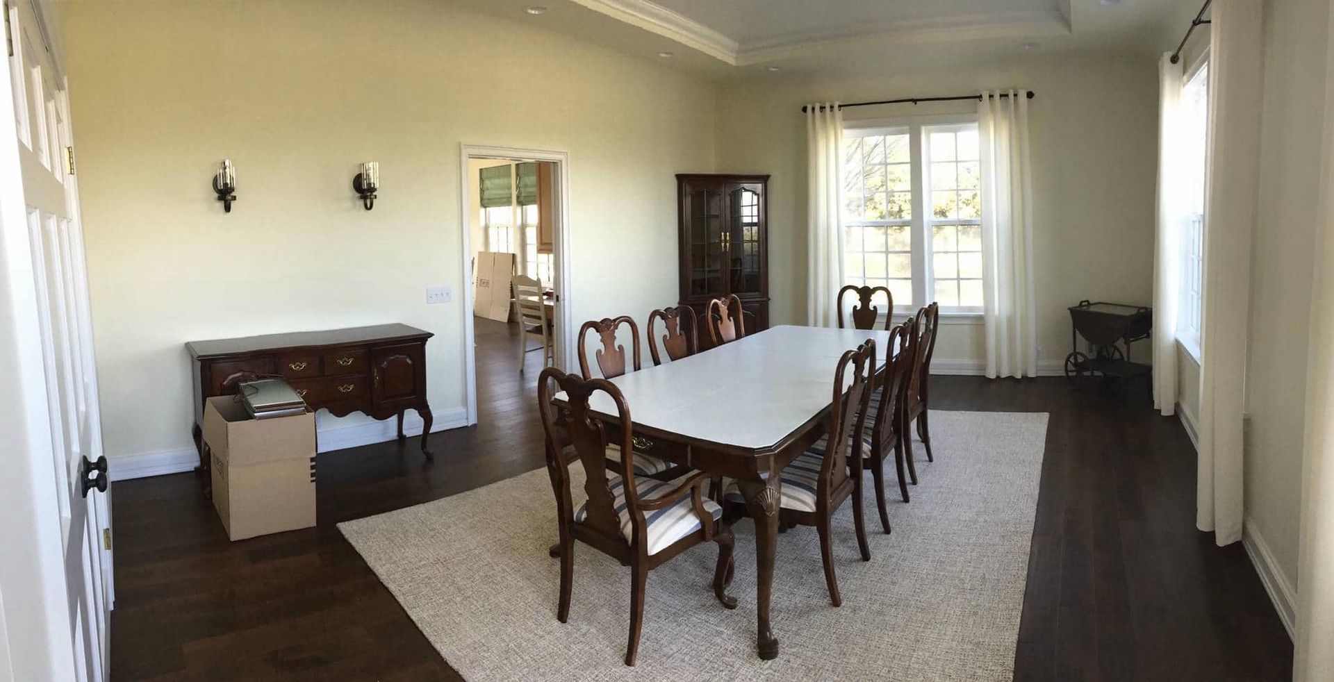 A large dining room with a long table and chairs