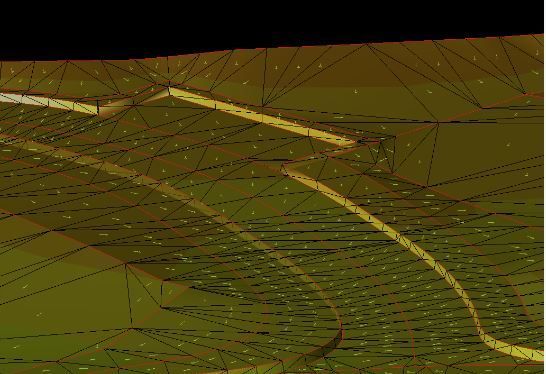 A man is sitting at a desk in front of a computer monitor.