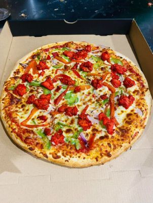 A Pizza with A Lot of Toppings Is in A Box — Gungahlin Kebab and Pizza in Gungahlin, ACT