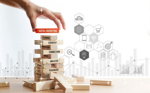 A person is stacking wooden blocks on top of each other on a table.