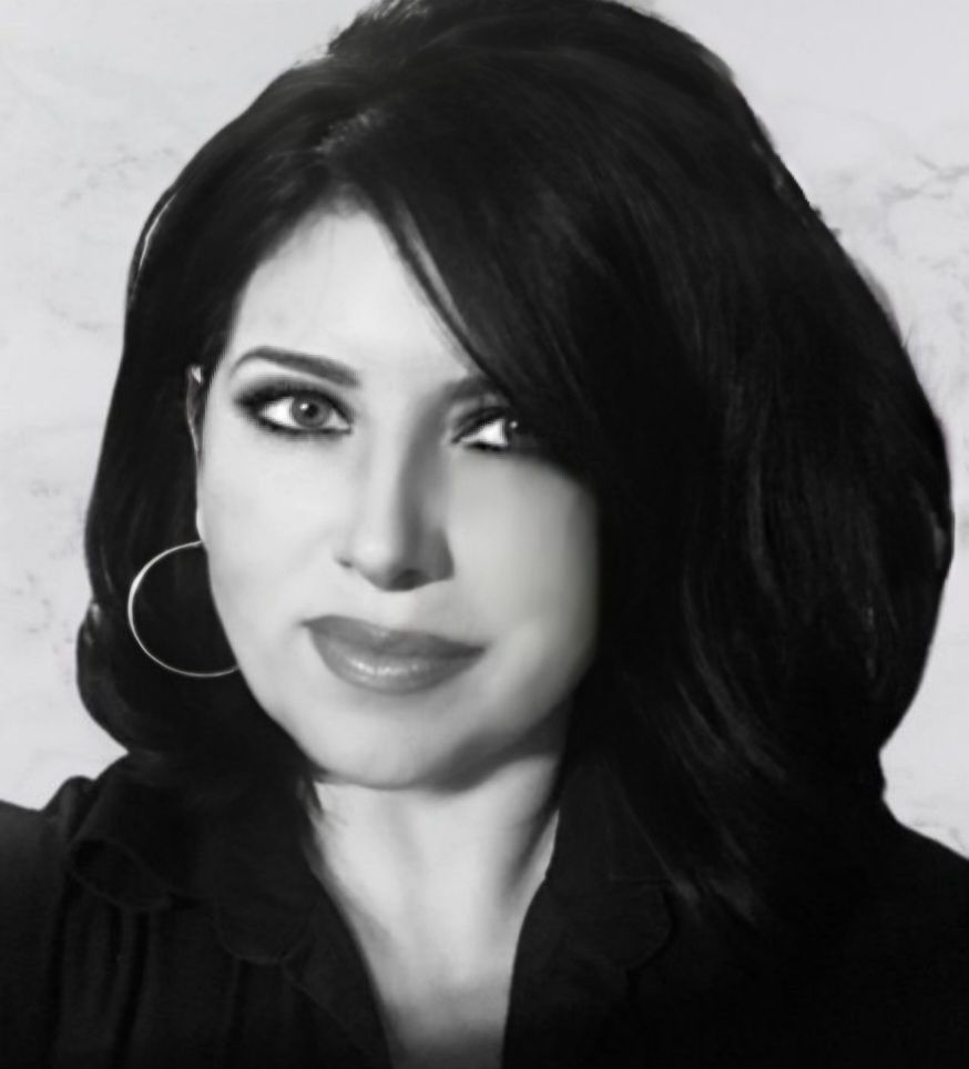 A black and white photo of a woman wearing hoop earrings