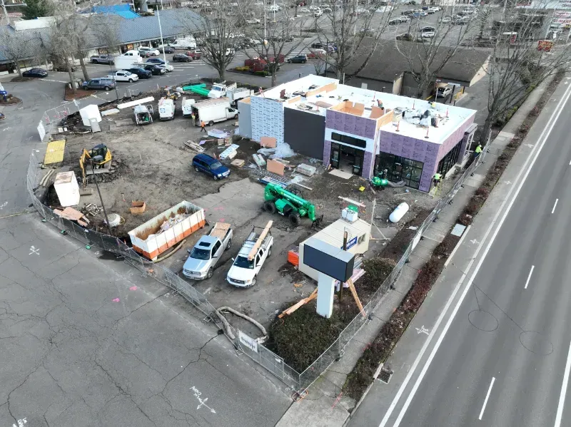 An aerial view of a building under construction with cars parked in front of it in Vancouver, WA