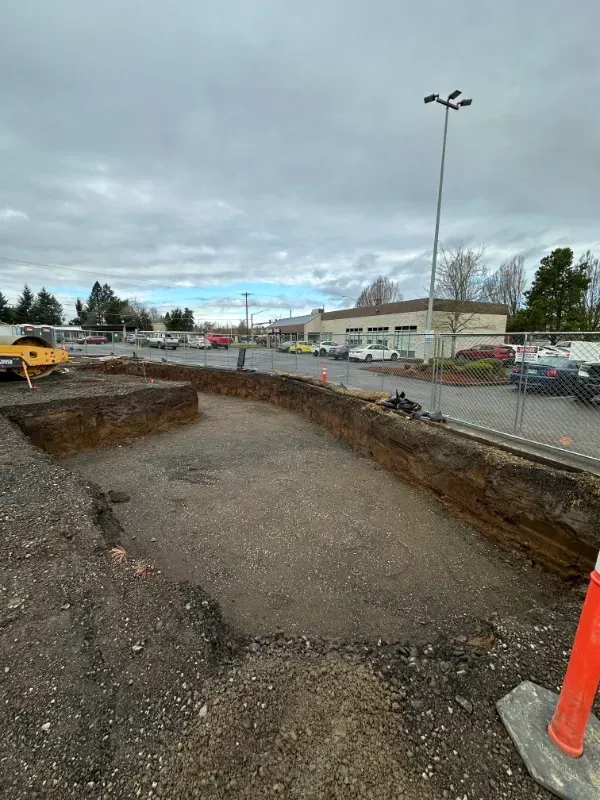 A construction worker is walking through a hole in the ground in Vancouver, WA