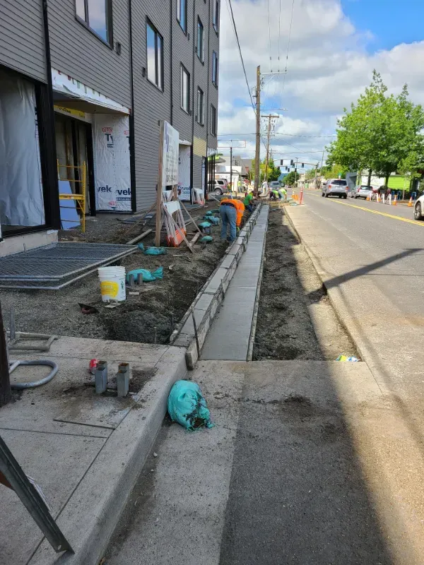 A concrete walkway is being built in front of a building under
construction in Vancouver, WA