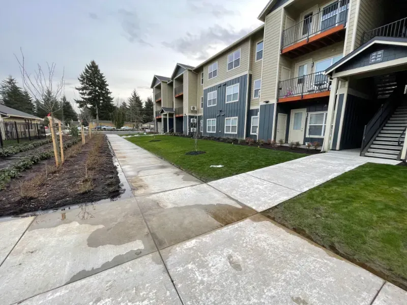 A concrete walkway is being built in front of a building under construction in Vancouver, WA