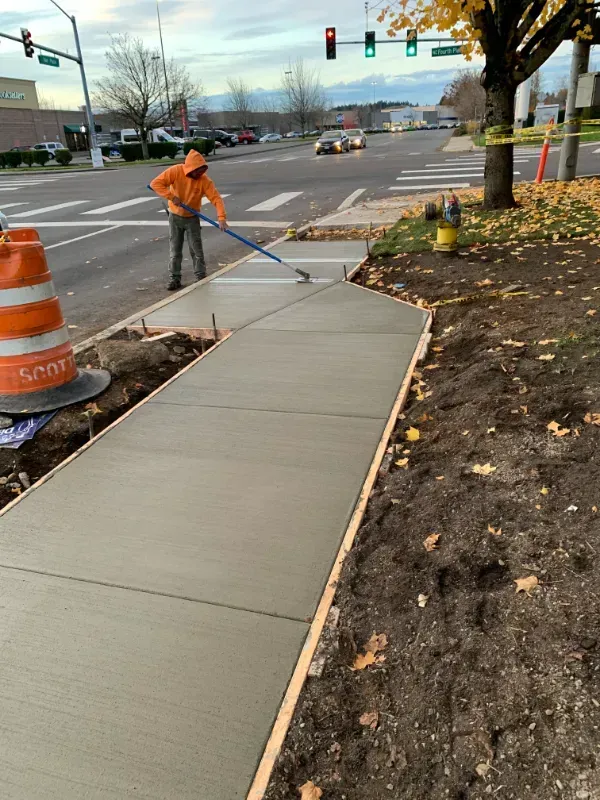 A concrete curb is being built in front of a building in Vancouver, WA