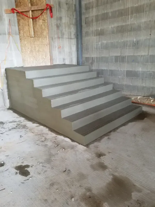 A concrete walkway is being built in front of a building under construction in Vancouver, WA