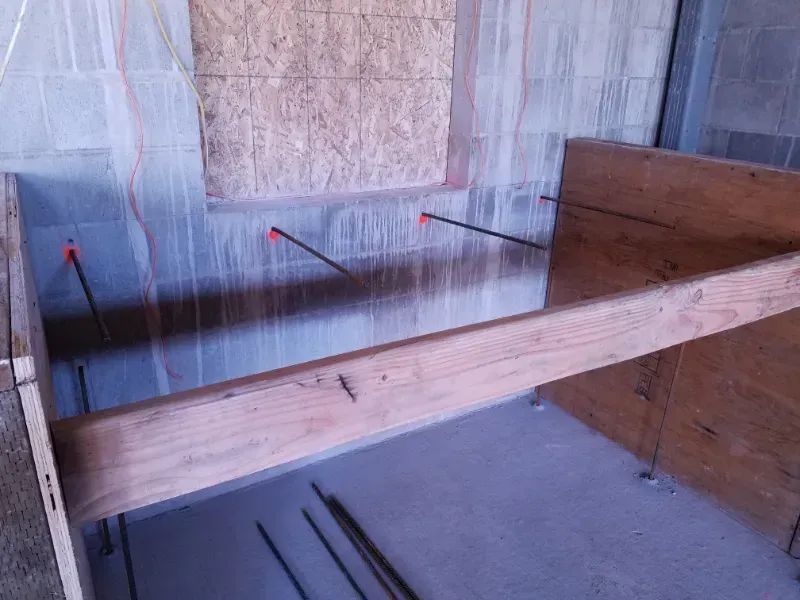 A concrete walkway is being built in front of a building under construction in Vancouver, WA