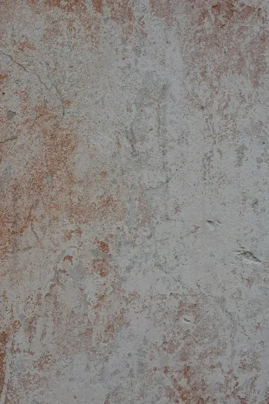 A close up of a white and brown tile with a marble texture.
