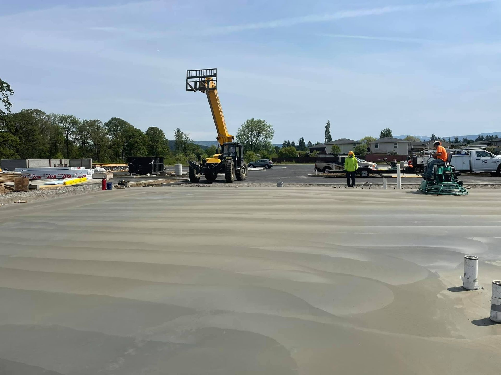 A group of construction workers are working on a concrete floor in Vancouver, WA by NAVA Concrete LLC