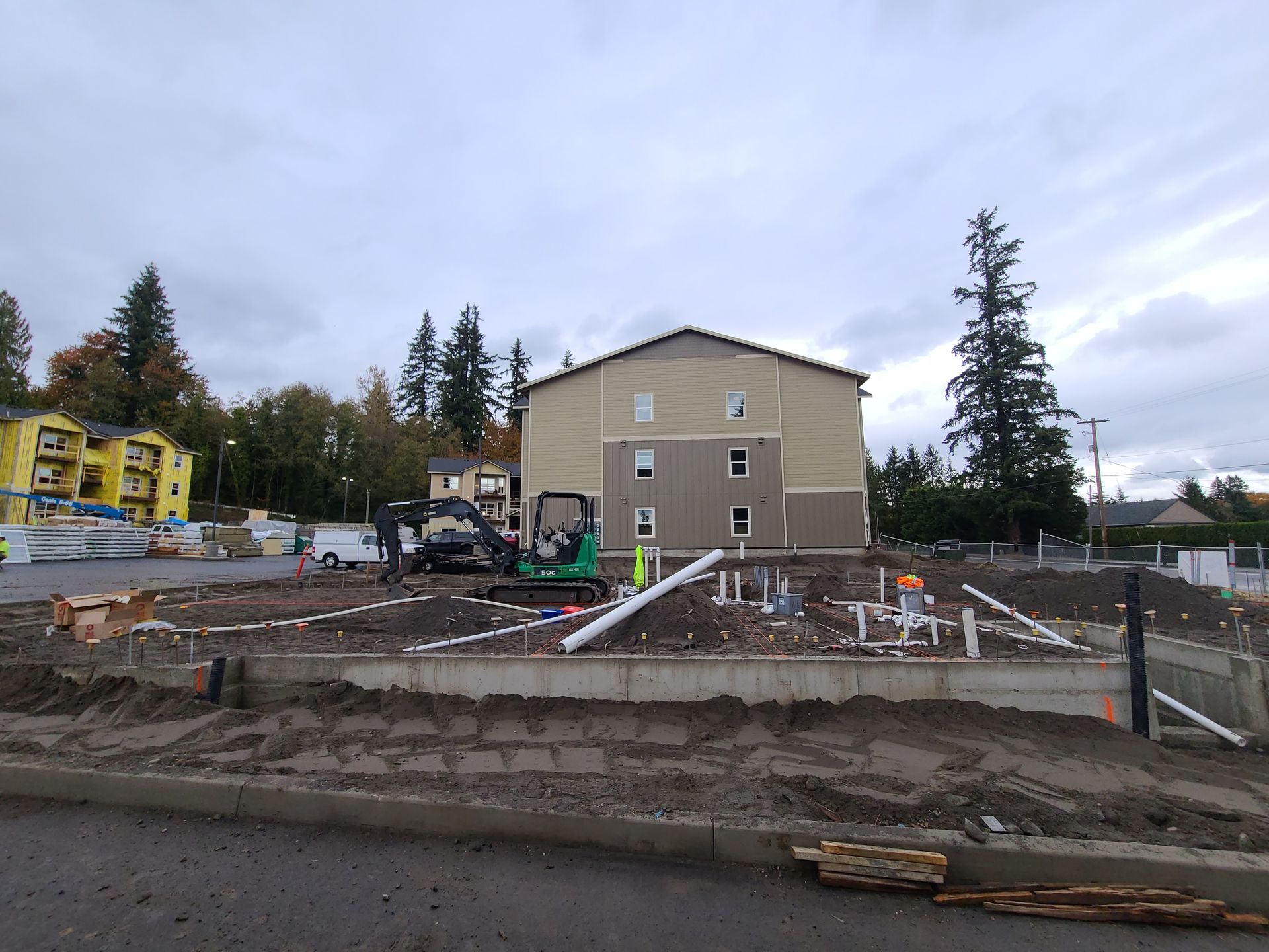 A concrete walkway is being built in front of a building under construction in Vancouver, WA