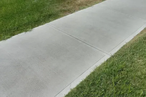 Concrete sidewalk bordered by green grass in Vancouver WA.