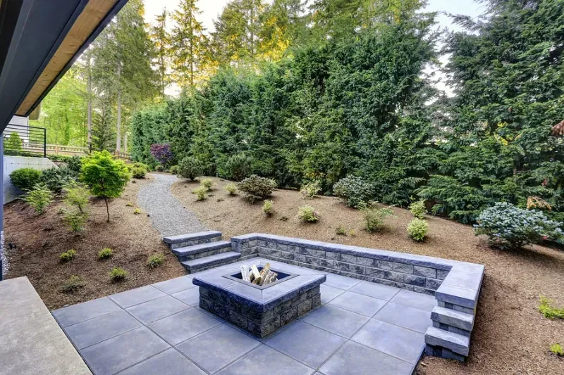 There is a fire pit in the middle of the patio.