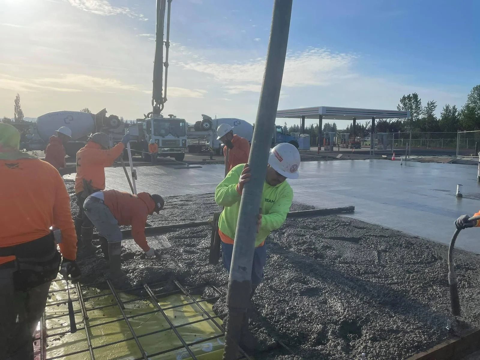 A group of construction workers are working on a concrete floor in Vancouver, WA by NAVA Concrete LLC