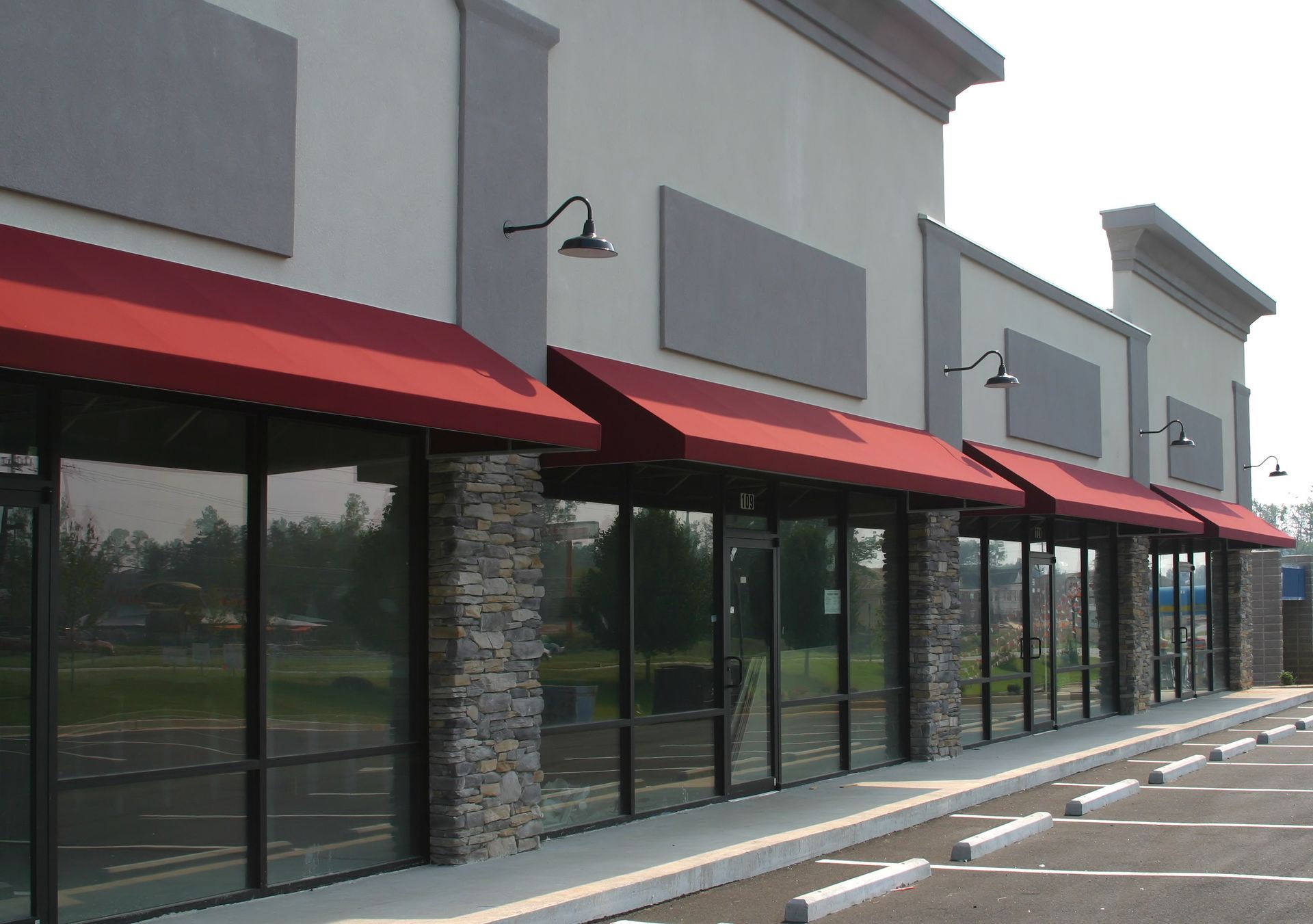 A building with a red awning on the side of it in Vancouver Washington by Nava Concrete LLC.
