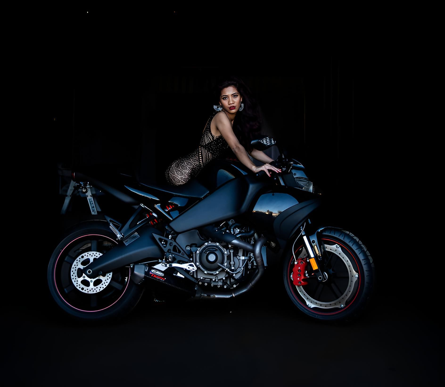 Woman is Sitting on a Motorcycle in the Dark — Lavie Hair & Beauty in Ciccone, NT