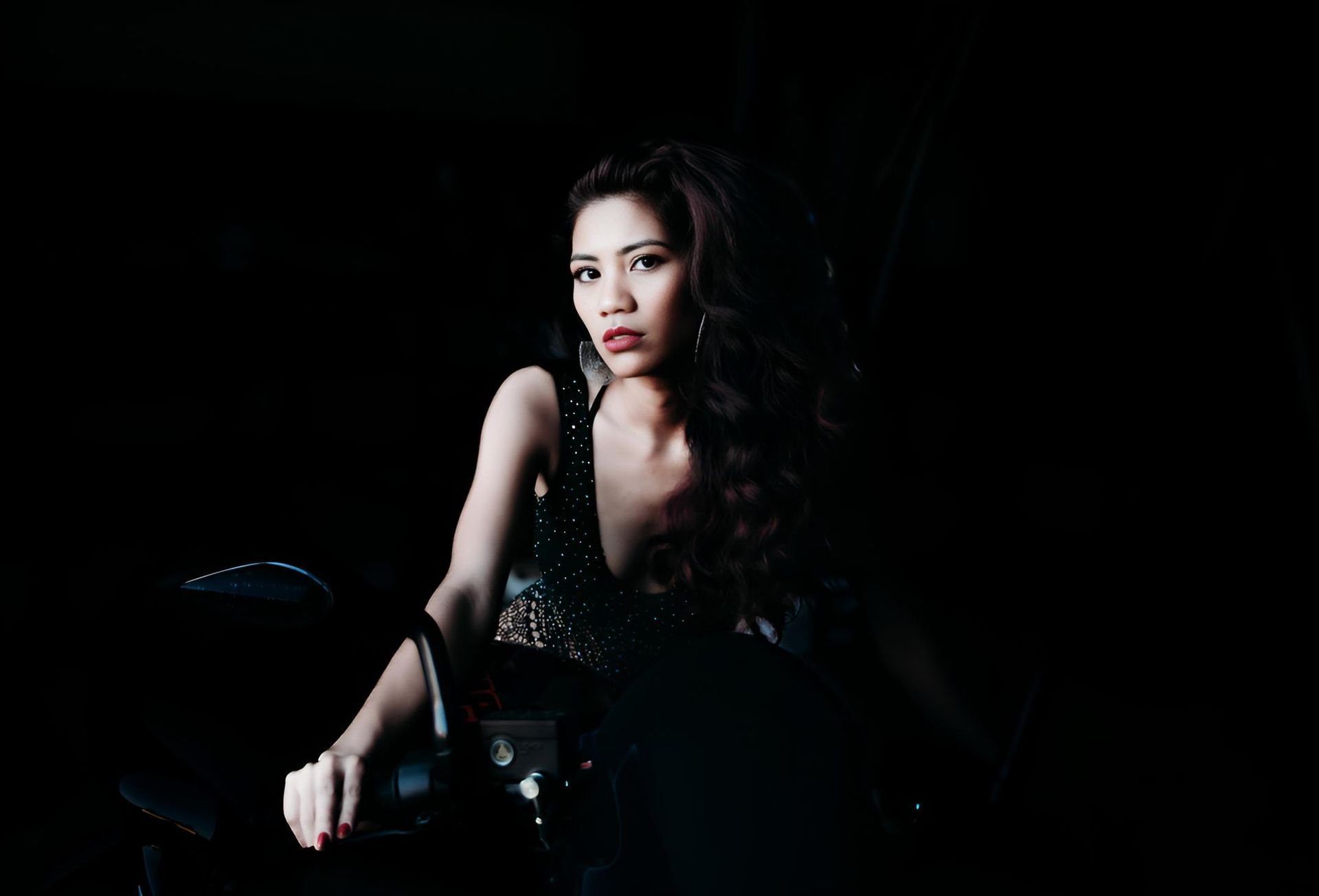 Woman in a Black Dress is Sitting on a Chair — Lavie Hair & Beauty in Ciccone, NT