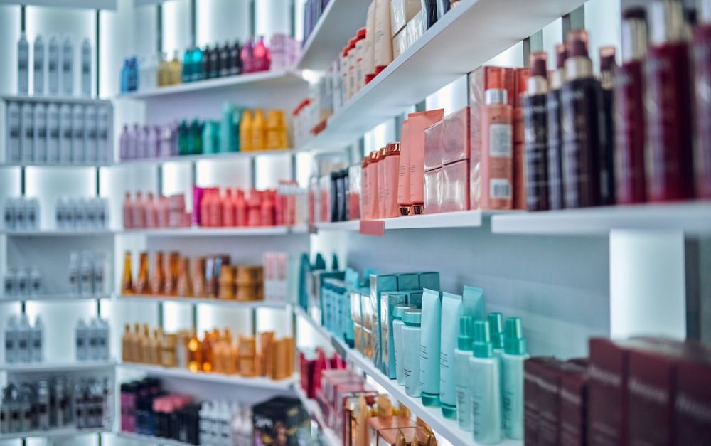 A row of shelves filled with lots of hair products in a pharmacy.