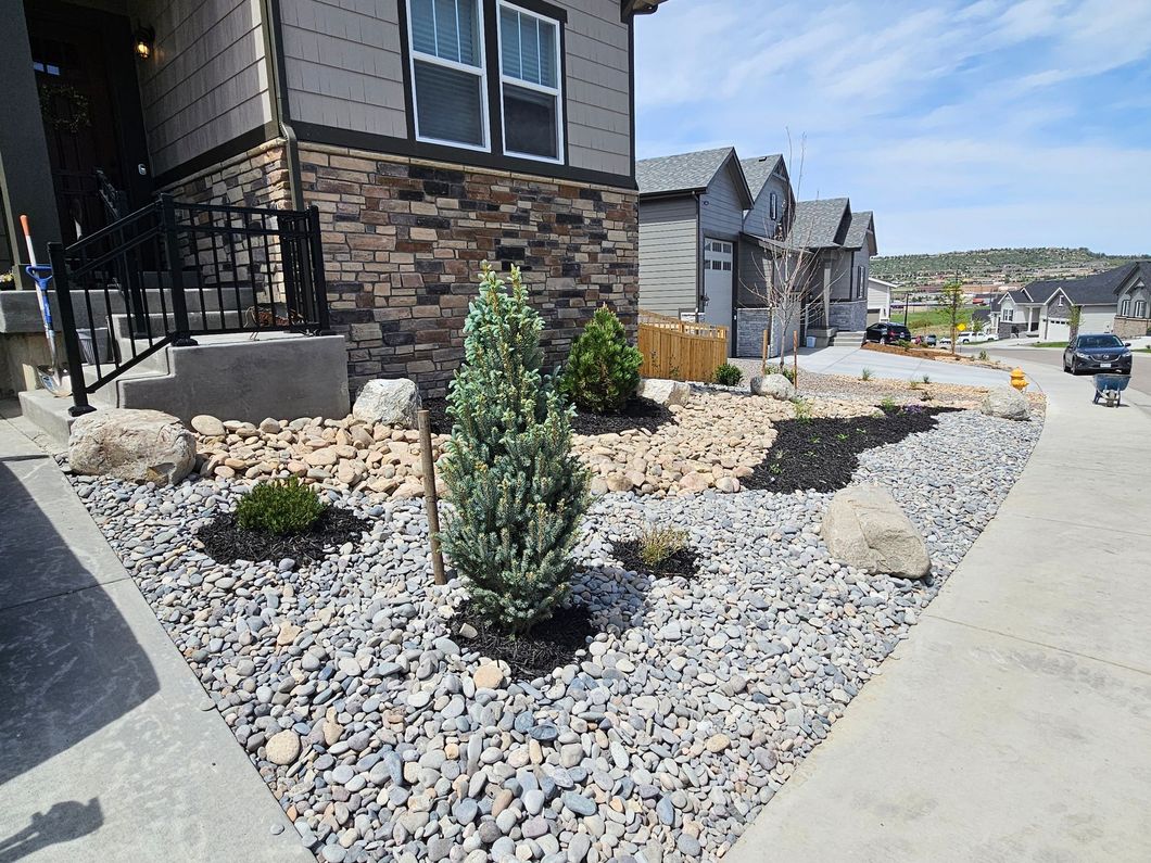 A house with a lot of rocks in front of it